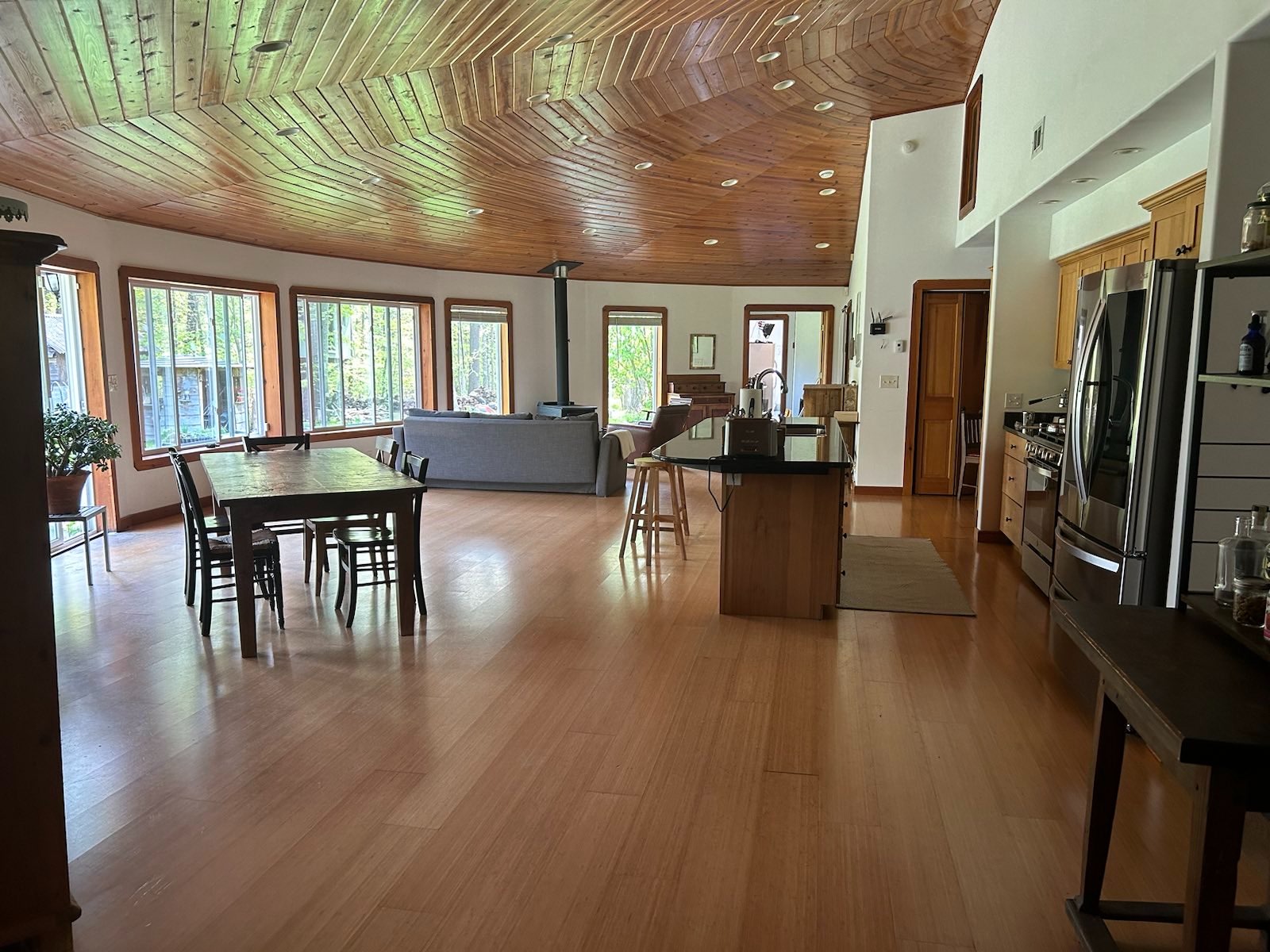 Great room, looking west, showing kitchen, dining area, and living area