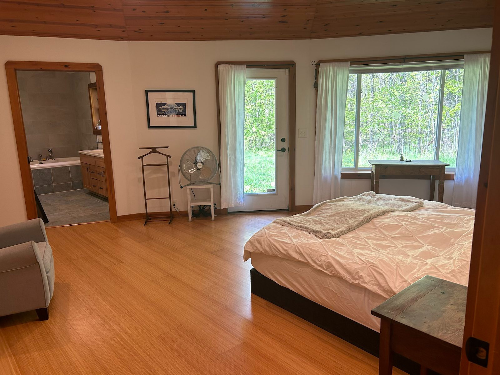 Main bedroom looking north. The rear door is a private entrance to the room, which has a main bathroom attached - with an enormous bathtub and separate shower (both rainshower head and handheld). There is a large, walk-in closet, and the sauna is in this room as well.